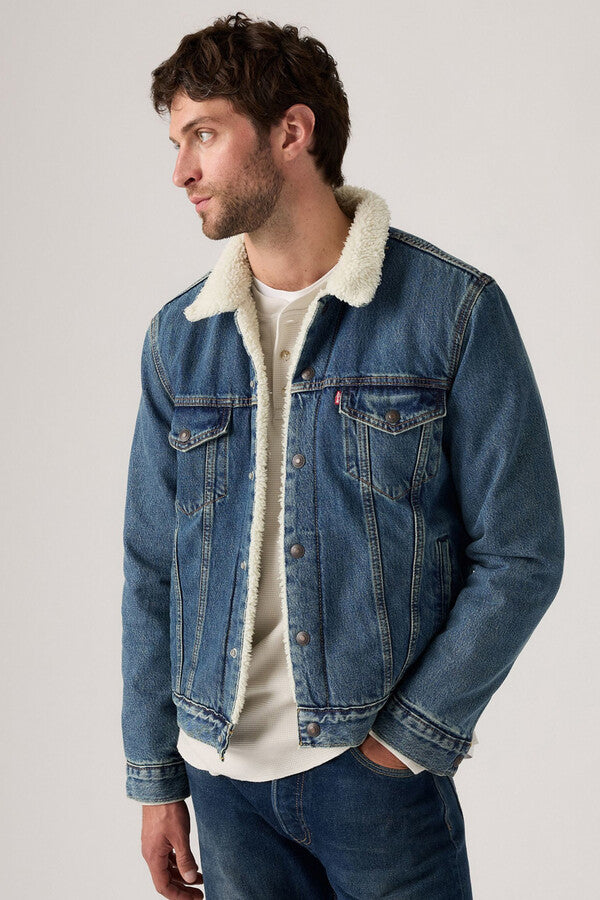 Classic denim jacket showing yoke seams, front placket, chest pockets, and structured collar