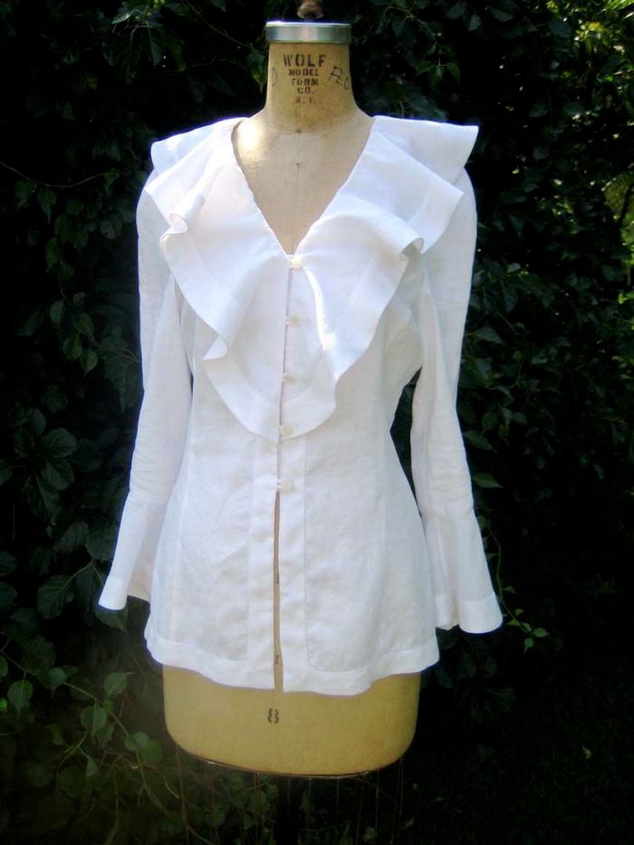 Flounce collar blouse showing soft draped collar waves, V-neckline, and button front opening
